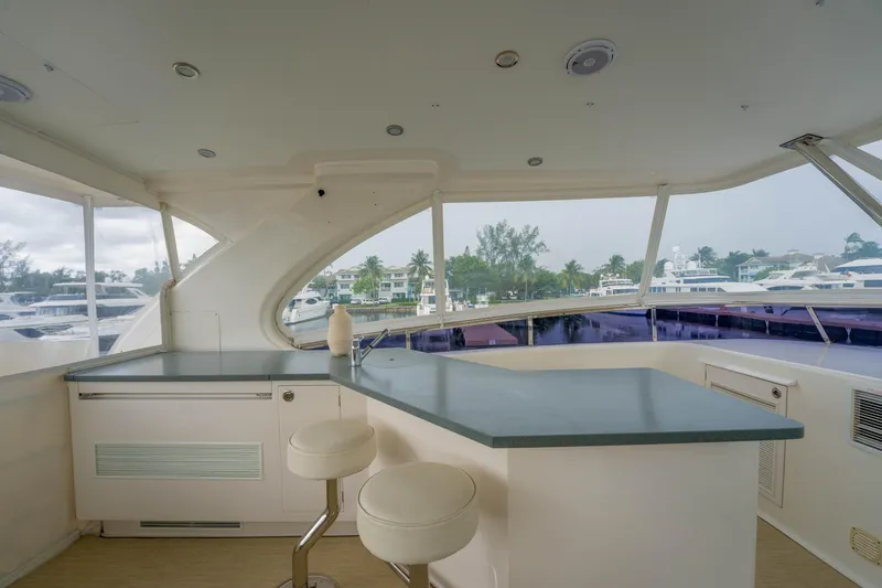 Slide: The Image of Luxurious 2016 Horizon PC60 yacht interior with modern bar and scenic marina view. - 55