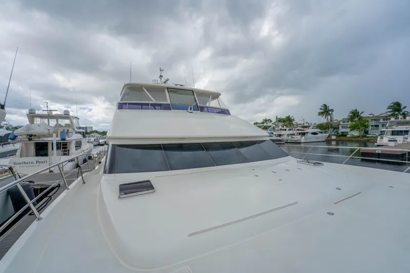 Slide: The Image of 2016 Horizon PC60 yacht docked at marina under cloudy skies. - 58