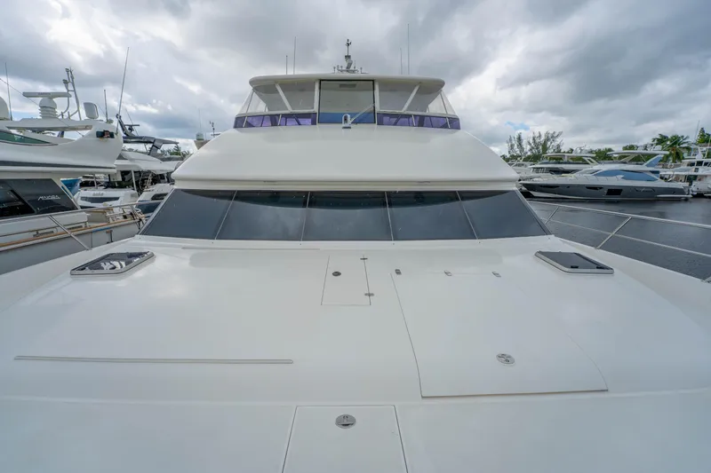 Slide: The Image of Front view of a 2016 Horizon PC60 yacht docked under cloudy skies. - 59