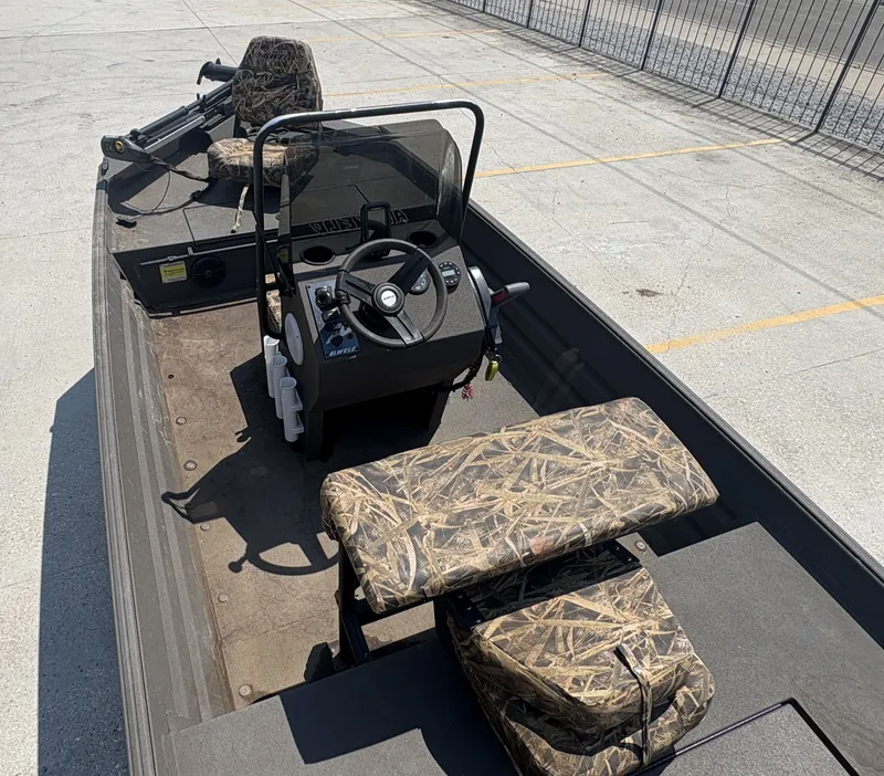 Slide: The Image of 2023 Alweld 16x52 Marsh boat on trailer at dealership, American flag displayed. - 3