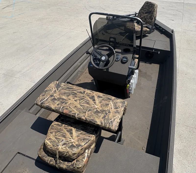 Slide: The Image of 2023 Alweld 16x52 Marsh boat interior with camouflage seating and steering console. - 6