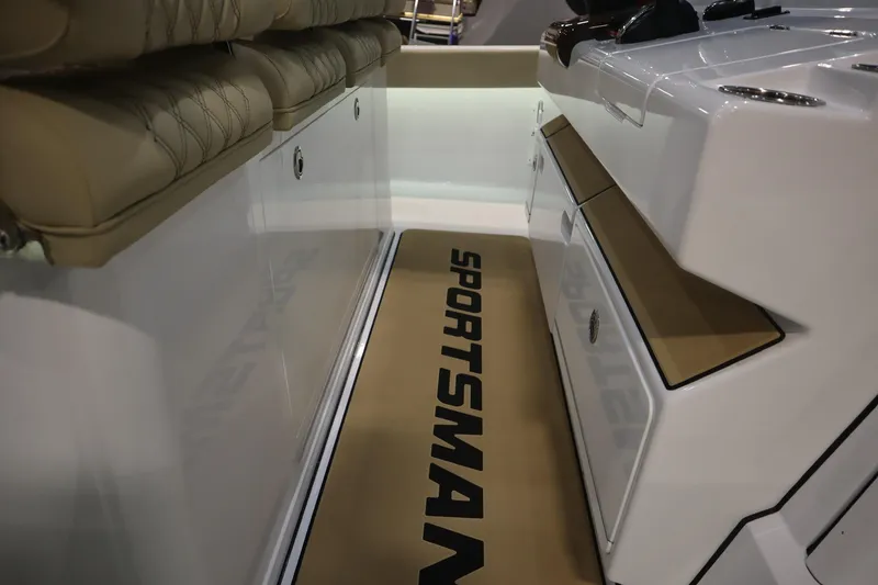Slide: The Image of 2026 Sportsman Open 402 Center Console interior with cushioned seating and storage compartments. - 10