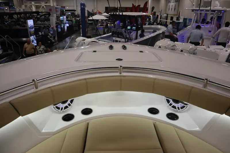 Slide: The Image of 2026 Sportsman Open 402 Center Console at a boat show, featuring luxurious seating and modern design. - 14