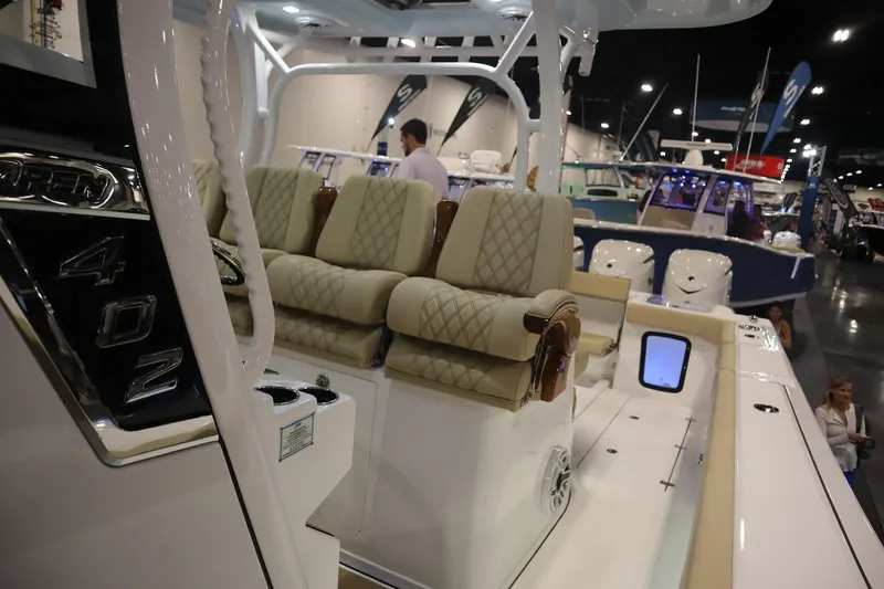 Slide: The Image of 2026 Sportsman Open 402 Center Console boat interior at a boat show. - 15