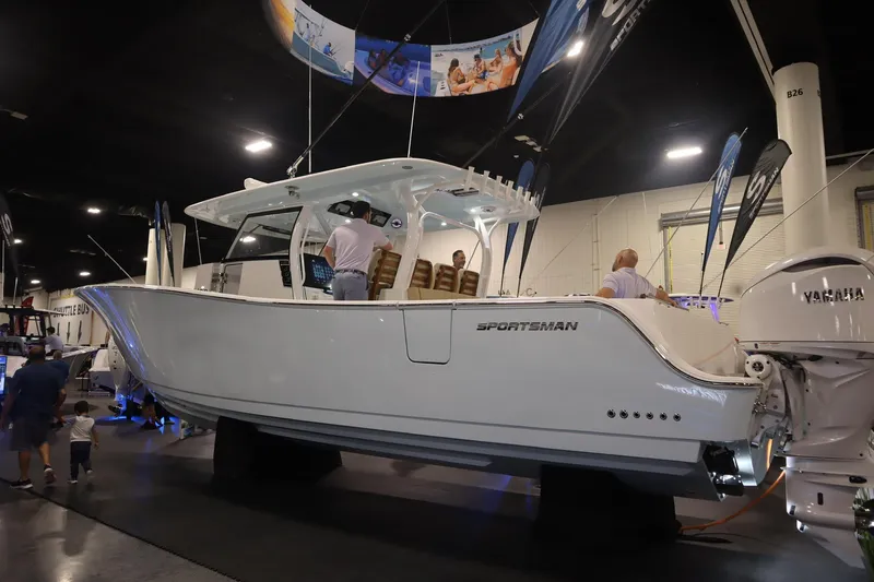 Slide: The Image of 2026 Sportsman Open 402 Center Console boat displayed at an indoor exhibition. - 4