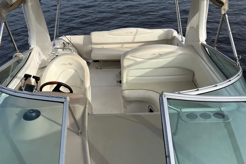 Slide: The Image of 2003 Sea Ray 280 Sundancer boat deck with hatch, on calm water. - 11