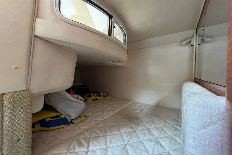 Slide: The Image of 2003 Sea Ray 280 Sundancer helm with steering wheel and branded seat. - 24