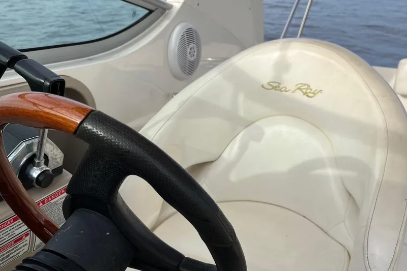 Slide: The Image of Interior of 2003 Sea Ray 280 Sundancer, featuring kitchenette, seating, and sleeping area. - 25