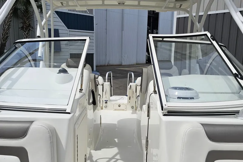 Slide: The Image of 2018 WorldCat 255 DC boat interior with open windshield and seating. - 11