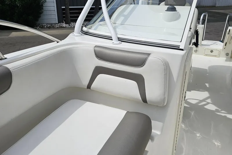 Slide: The Image of Interior seating of 2018 WorldCat 255 DC boat, featuring white and gray upholstery. - 13