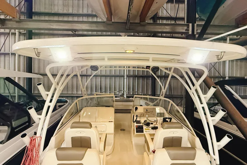 Slide: The Image of 2018 WorldCat 255 DC boat interior with seating and control panel in storage. - 18
