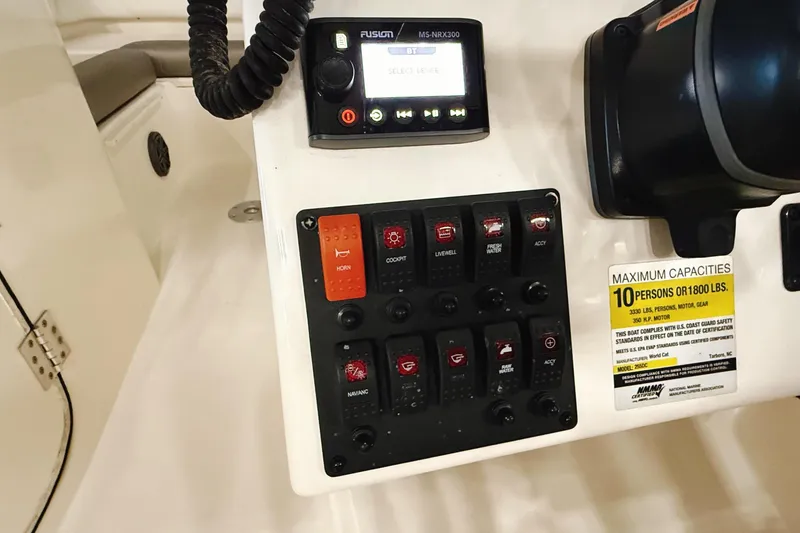 Slide: The Image of Control panel of a 2018 WorldCat 255 DC boat with capacity and safety labels. - 21