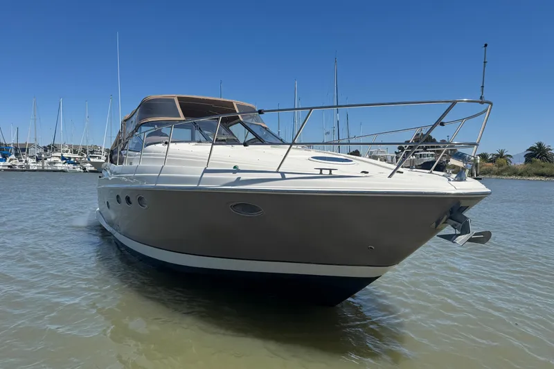 Slide: The Image of 2002 Regal Commodore 3860 yacht in marina, clear sky, calm water. - 10