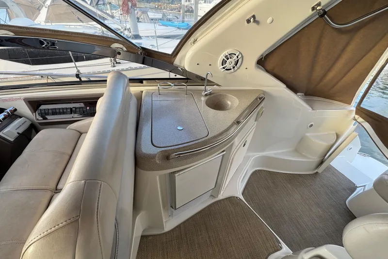 Slide: The Image of Interior of 2002 Regal Commodore 3860 yacht with seating and kitchenette area. - 14