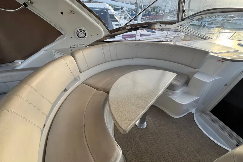 Slide: The Image of Interior of 2002 Regal Commodore 3860 yacht with curved seating and table. - 16