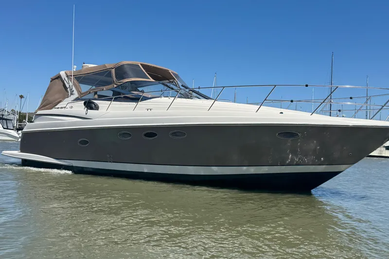 Slide: The Image of 2002 Regal Commodore 3860 yacht on calm water under clear blue sky. - 2