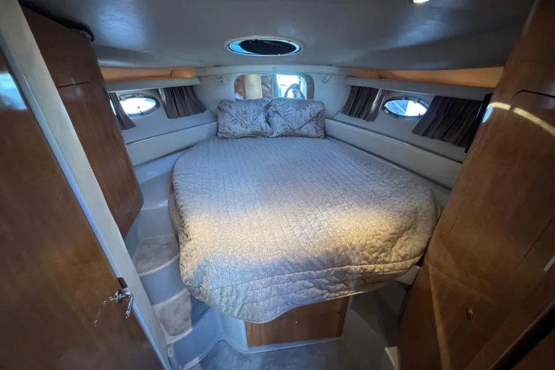 Slide: The Image of Luxurious cabin interior of 2002 Regal Commodore 3860 yacht with cozy bed and wood finish. - 22