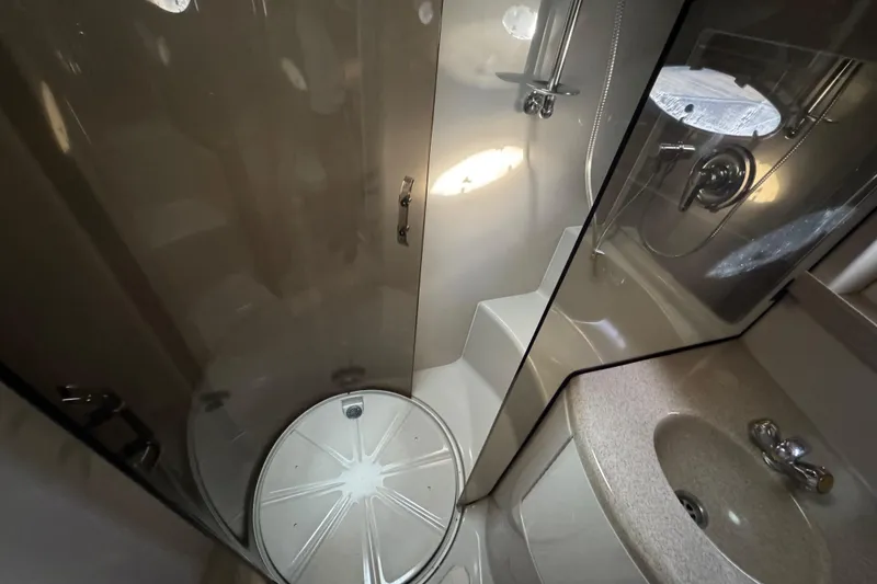 Slide: The Image of Bathroom interior of 2002 Regal Commodore 3860 yacht, featuring shower and sink. - 24