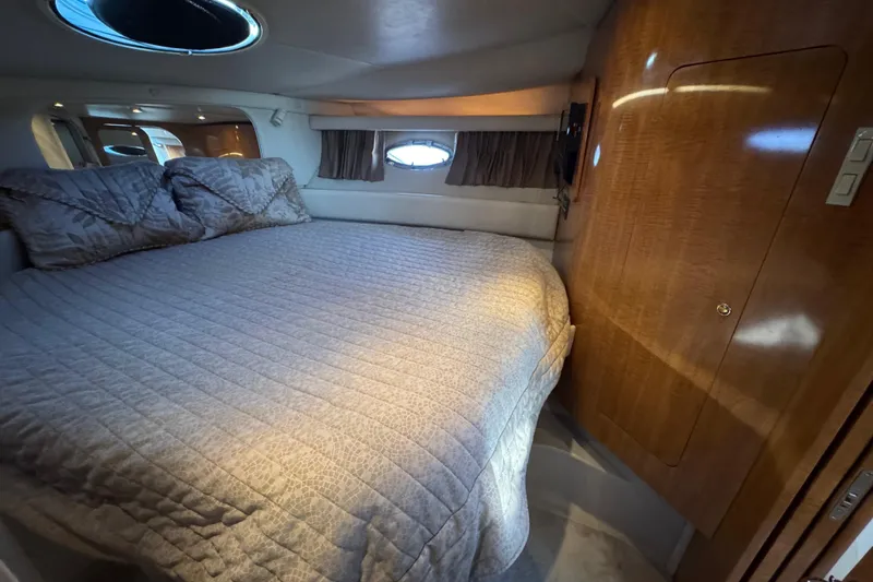 Slide: The Image of Luxurious bedroom interior of 2002 Regal Commodore 3860 yacht with cozy bedding. - 25