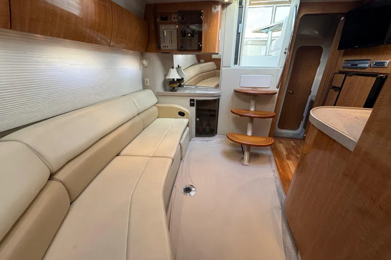 Slide: The Image of Interior of 2002 Regal Commodore 3860 yacht with beige seating and wooden accents. - 26