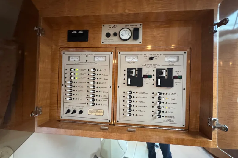 Slide: The Image of Electrical control panel of a 2002 Regal Commodore 3860 boat, featuring switches and gauges. - 28
