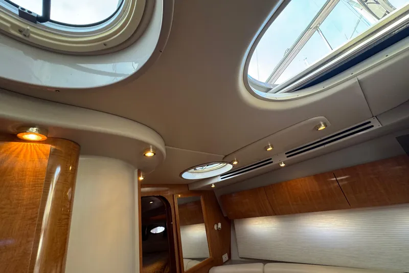 Slide: The Image of Interior of 2002 Regal Commodore 3860 yacht with skylights and wood paneling. - 31