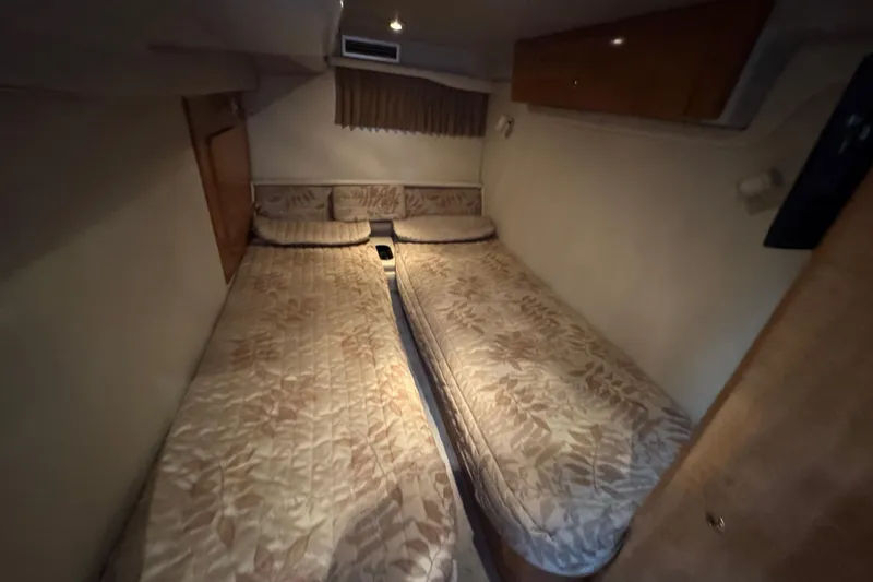 Slide: The Image of Interior cabin of 2002 Regal Commodore 3860 with twin beds and floral bedding. - 35