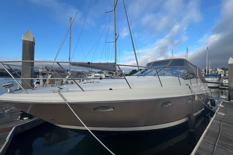 Slide: The Image of 2002 Regal Commodore 3860 yacht docked at marina under blue sky. - 41
