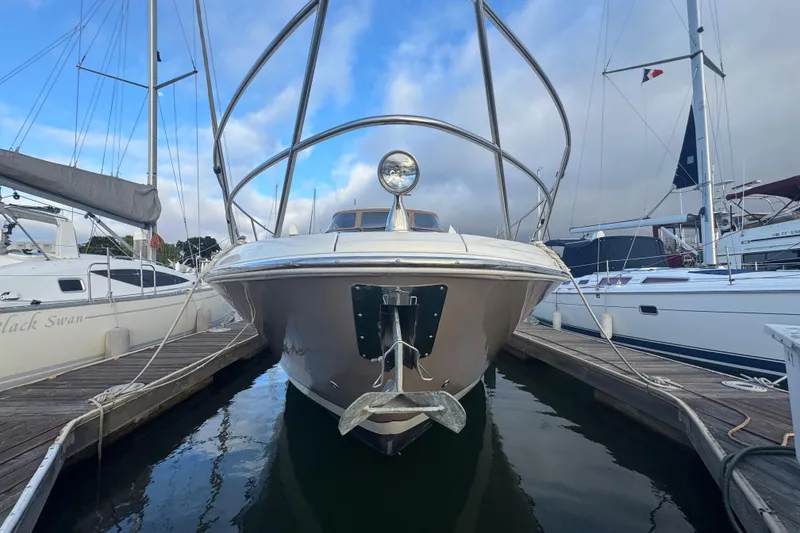 Slide: The Image of 2002 Regal Commodore 3860 yacht docked at marina, front view with clear sky. - 42