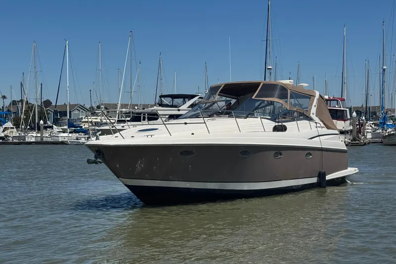 Slide: The Image of 2002 Regal Commodore 3860 yacht docked in a marina with sailboats in the background. - 5