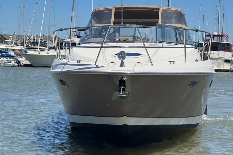 Slide: The Image of 2002 Regal Commodore 3860 yacht docked in a marina, front view. - 9