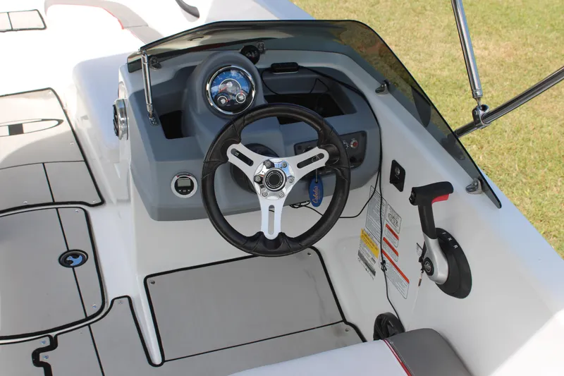 Slide: The Image of 2021 Tahoe T16 boat cockpit with steering wheel and control panel. - 12