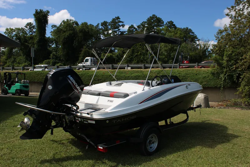 Slide: The Image of 2021 Tahoe T16 boat with Mercury engine on trailer, parked on grass. - 18