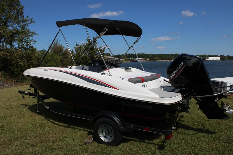 Slide: The Image of 2021 Tahoe T16 boat with Mercury engine by a lake on a sunny day. - 7