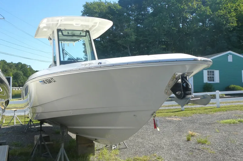 Slide: The Image of 2023 Boston Whaler 280 Dauntless boat displayed outdoors on stands. - 1