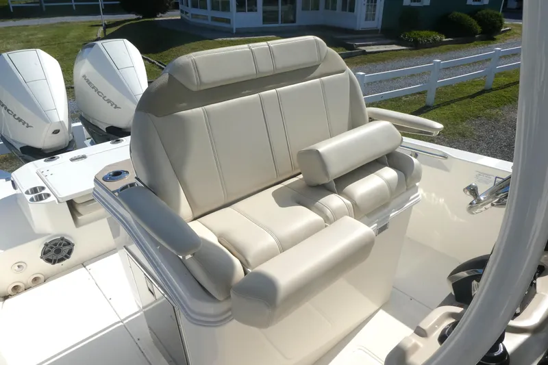 Slide: The Image of 2023 Boston Whaler 280 Dauntless boat seat with dual Mercury engines in background. - 10