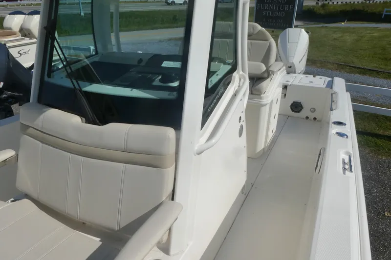 Slide: The Image of 2023 Boston Whaler 280 Dauntless boat interior with seating and console. - 12