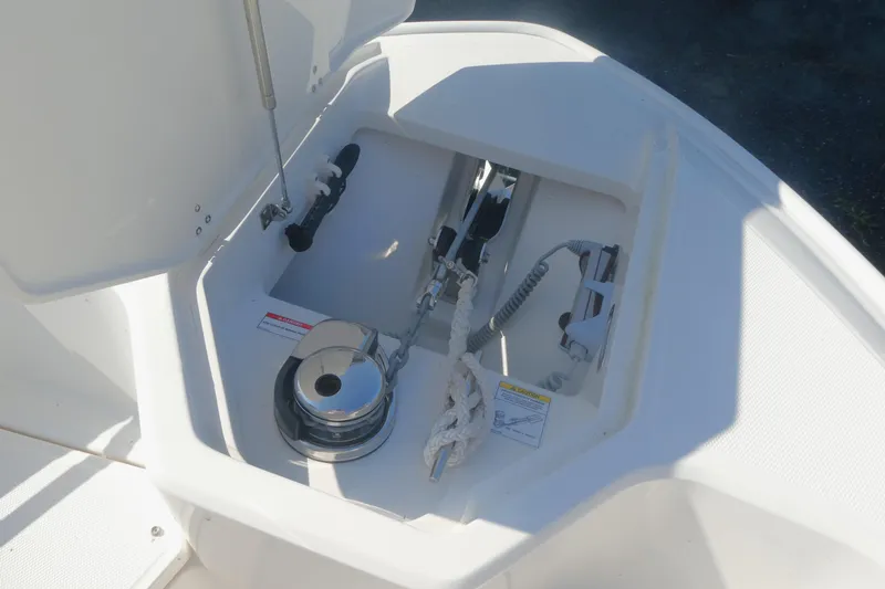Slide: The Image of 2023 Boston Whaler 280 Dauntless anchor compartment with winch and rope storage. - 13