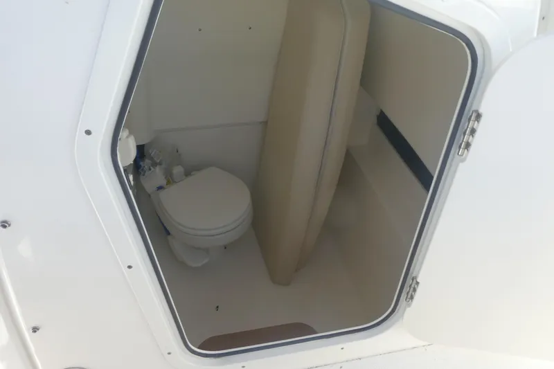Slide: The Image of 2023 Boston Whaler 280 Dauntless boat interior with compact marine toilet. - 14