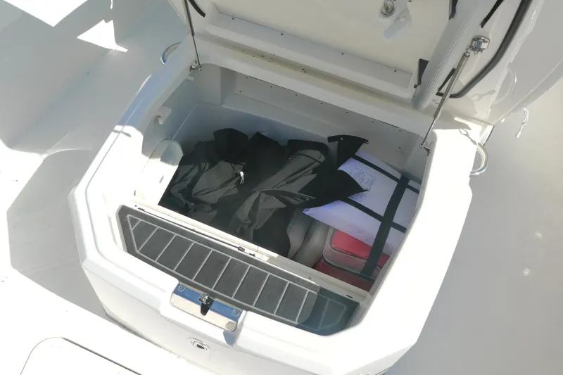 Slide: The Image of Storage compartment on 2023 Boston Whaler 280 Dauntless boat, containing life jackets and gear. - 15