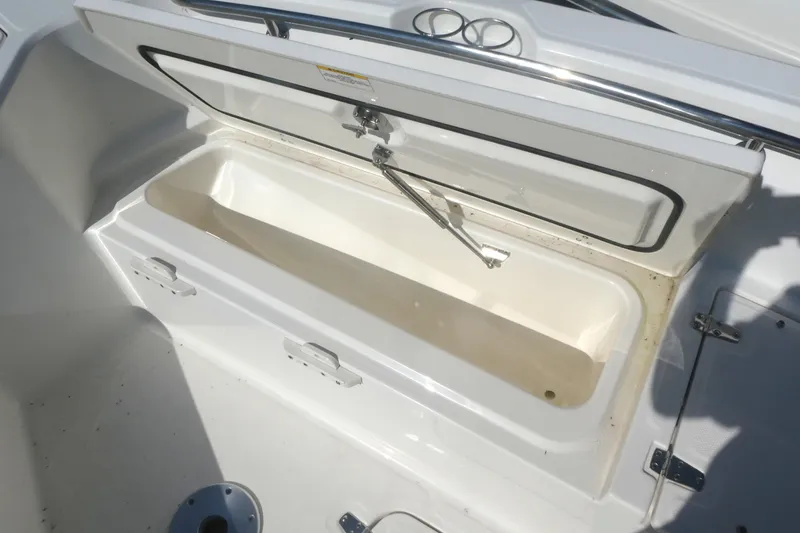 Slide: The Image of Open storage compartment on 2023 Boston Whaler 280 Dauntless boat. - 16