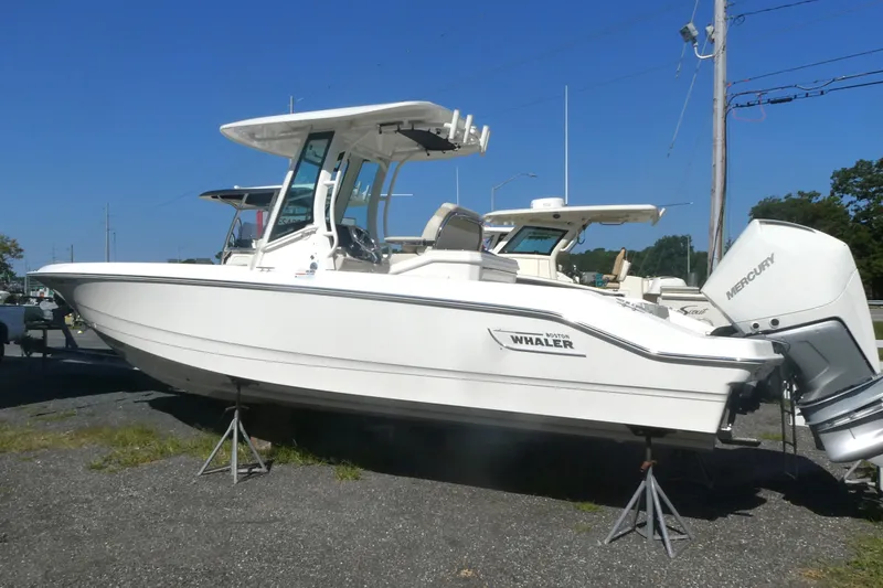 Slide: The Image of 2023 Boston Whaler 280 Dauntless boat on display, featuring dual Mercury engines. - 2