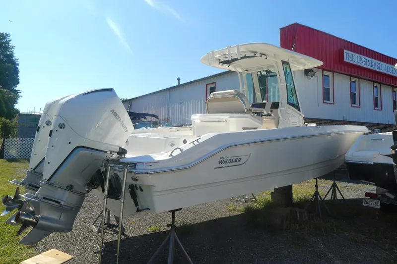 Slide: The Image of 2023 Boston Whaler 280 Dauntless boat with dual engines, displayed outdoors. - 3