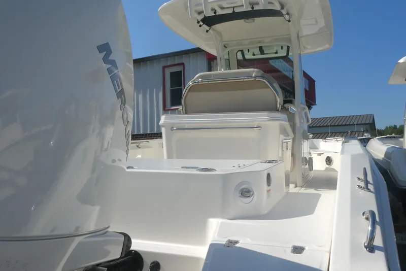 Slide: The Image of 2023 Boston Whaler 280 Dauntless boat with Mercury engine, docked under clear blue sky. - 4