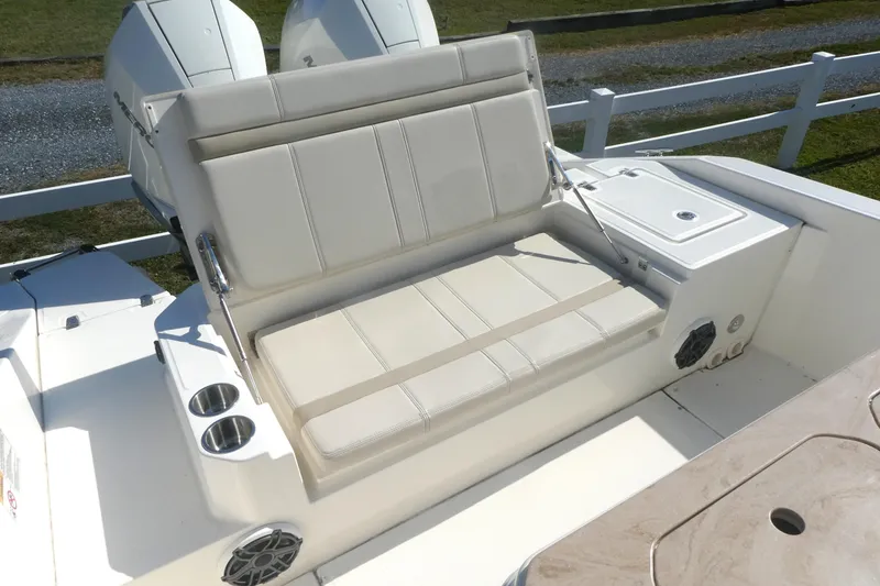 Slide: The Image of 2023 Boston Whaler 280 Dauntless boat seating area with cup holders and storage. - 8