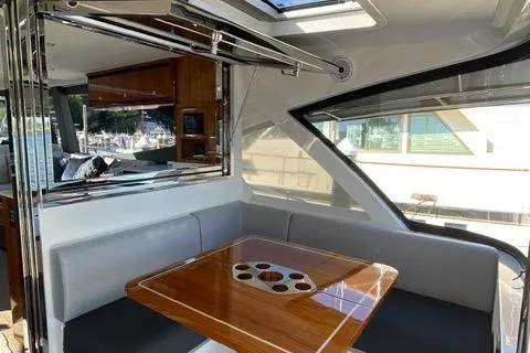 Slide: The Image of Luxurious interior of 2025 Riviera 585 SUV yacht with elegant dining area. - 14