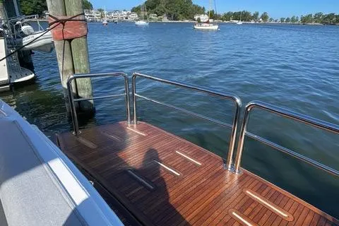 Slide: The Image of Luxury 2025 Riviera 585 SUV yacht deck with scenic waterfront view. - 22