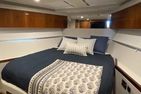 Slide: The Image of Luxurious bedroom interior of 2025 Riviera 585 SUV yacht with elegant bedding. - 26