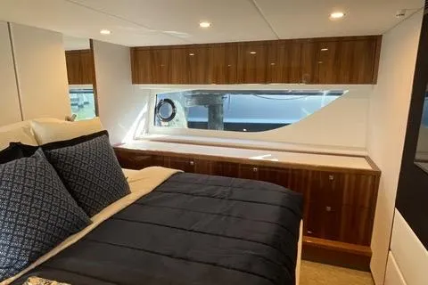 Slide: The Image of Luxurious bedroom interior of 2025 Riviera 585 SUV yacht with elegant wood finishes. - 29