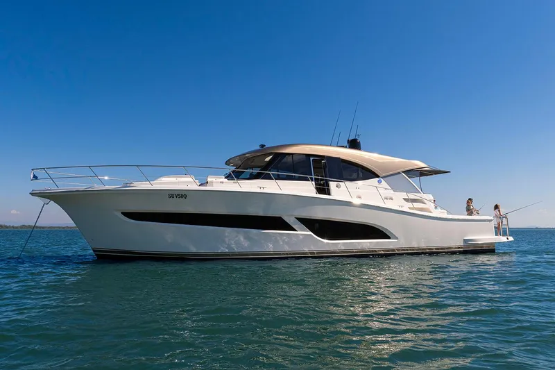 Slide: The Image of Manufacturer Provided Image: 2025 Riviera 585 SUV yacht cruising on open water under clear blue sky. - 36